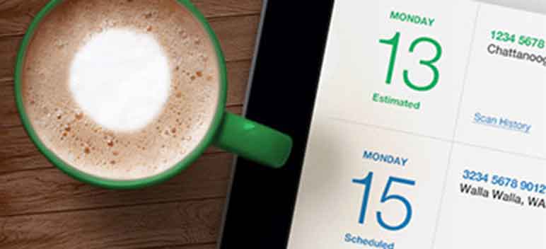 A coffee cup sits next to a day planner.